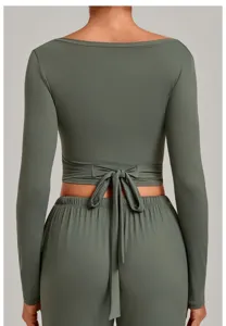 Back view detail of an olive green long sleeve wrap yoga top with stylish back tie closure.