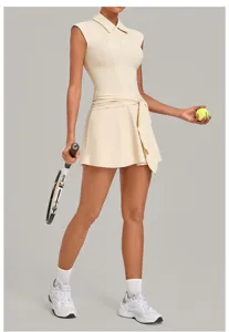 Sleeveless polo tennis dress in apricot color, featuring a tied waist and comfortable athletic fit.