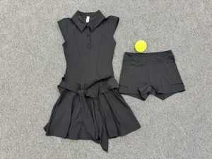 Detailed flat lay view of a black athletic tennis dress and shorts set with belt.