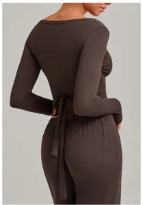 Back detail view of a brown long sleeve wrap yoga top and pants set, perfect for fitness workouts.