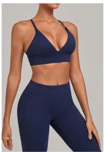 Close-up of dark blue sports bra and yoga leggings, showing adjustable straps and fit.