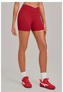 Close-up of dark red high-waisted crossover yoga shorts, soft stretch active bottoms.