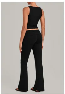Black yoga set back detail, sleeveless crop top and fold-over waist flare fitness pants.