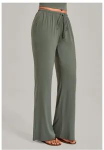 Detail view of sage green casual yoga pants, featuring elastic drawstring waist and wide leg.