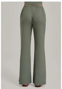 Back view detail of women's green wide-leg yoga pants with elastic waist and loose draped fit.