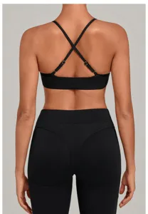 Detailed back view of the black sports bra featuring adjustable criss-cross straps, yoga.