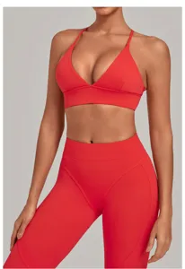 Detailed close-up view of red athletic sports bra and high waist fitness leggings.