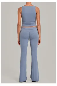 Back detail of light blue yoga set featuring sleeveless tank and fold-over flare pants.