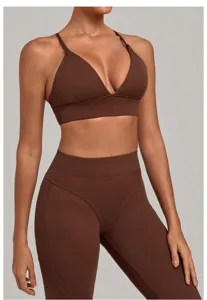Close up view of the brown athletic bra and high waist leggings showing smooth fabric texture.