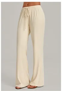 Detailed shot of beige wide-leg yoga pants featuring a comfortable drawstring elastic waist.