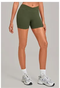 Olive green high waist crossover yoga shorts, fitted activewear for running and fitness.