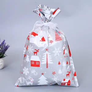 Weihnachtsgeschenk Aufbewahrungstasche mit festlichen Rentier Haus Schnee Mustern und Band.