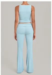 Light blue yoga two-piece set, sleeveless crop top and flare pants with fold-over waist detail.