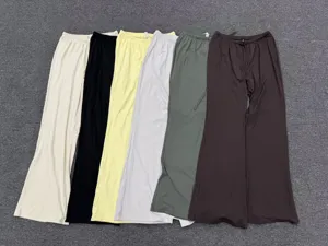 Close-up detail showing multiple colors of loose wide-leg yoga lounge pants with drawstring.