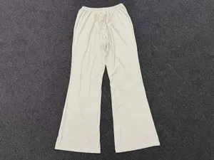 Close-up detail of women's loose drape wide-leg yoga trousers in cream white, comfy and smooth.