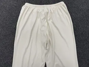 Detail view of women's loose casual drape wide-leg trousers with elastic waist design.