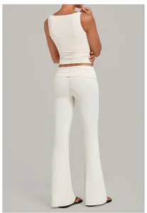 Rear view of a beige sleeveless crop top and matching high waist flared yoga pants.