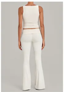 Back detail of cream ribbed tank top and flared yoga pants with folded waistband activewear.