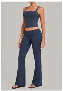 Dark blue yoga set detail showing fold-over waist and slim fit design for fitness workouts.