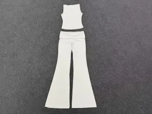 White yoga outfit set featuring a sleeveless top and fold-over waist flare pants for fitness.