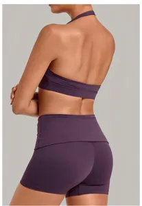 Back detail view of deep purple halter sports bra and high-waisted yoga shorts set.