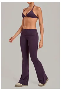 Dark purple halter sports bra and high-waisted folded flare yoga pants set for fitness workout.