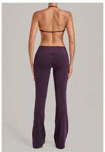 Detailed back view of the dark purple halter bra and fold-over flare yoga pants set.