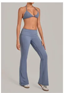 Detailed shot of the halter sports bra and fold-over waist yoga pants set, elegant blue.