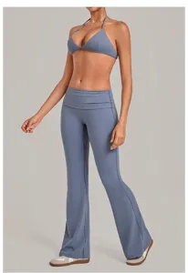 Detailed view of the halter sports bra and foldover flare yoga pants in stylish greyish blue.