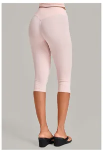 Detail view of the pink crop top and high-waist capri yoga leggings back side display.