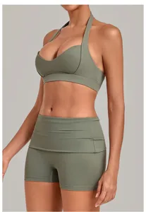 Detailed view of the olive green halter sports bra and high-waist yoga shorts workout set.