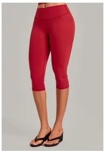 Red high-waisted cropped yoga pants detail showcasing fitness fit, capri length design.