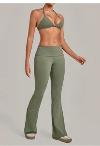 Green halter sports bra and folded waist flare yoga pants set for fitness and workouts.