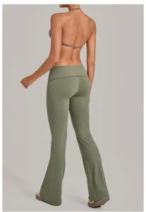 Detail view of the green halter bra and fold-over waist flare yoga pants set showing fit.