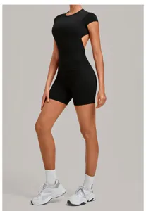 Detail view of black backless yoga top and biker shorts activewear set for women fitness.