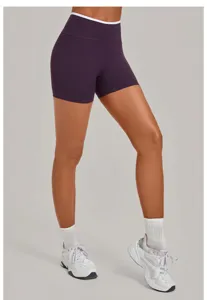 Detailed view of high-waist purple yoga shorts with contrast white binding for fitness.