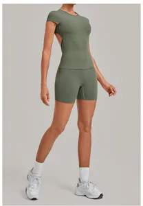 Detail shot of backless yoga top and tight shorts set, comfortable workout fitness wear.