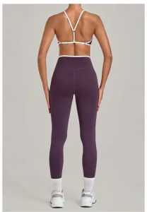 Back view detail of purple yoga sports bra with white contrast straps and high waist leggings.