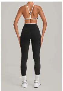 Detail view of contrast trim sports bra and high waist leggings for fitness and running workout.