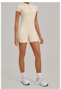 Beige short sleeve half-zip athletic romper detail showcasing tight fit and zip collar.