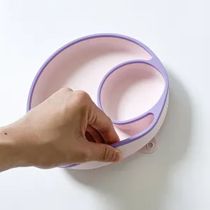 Silicone baby suction plate detail, pink and purple partitioned infant dining tray, flexible.