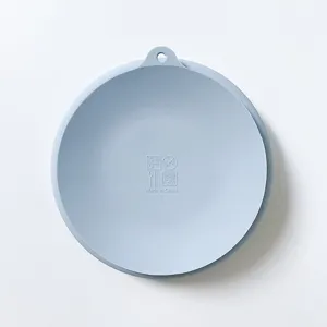 Detailed view of baby silicone suction plate in light blue, showing hanging hole and safe icons.