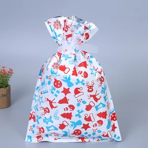Weihnachtsgeschenkbeutel mit festlichen rot-blauen Motiven und weißem Kordelzug für Naschereien.