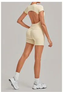 Back view of a beige open-back short sleeve top and scrunch bum yoga shorts activewear set.