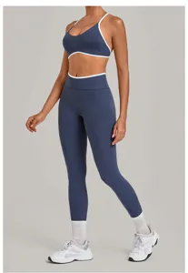 Dark blue yoga set with white trim, featuring a strappy sports bra and high-waisted leggings.