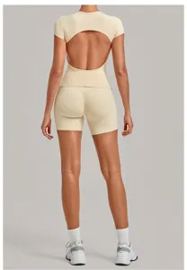 Beige open-back yoga top and ruched biker shorts activewear set for women fitness gym.