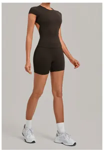Backless short-sleeve yoga top and biker shorts set detail view, activewear close-up.