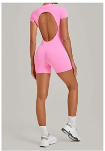 Detail view of the pink backless yoga jumpsuit showing back cutout and body shaping fit.