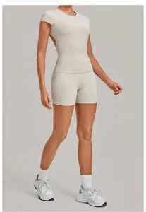 Backless yoga set with short sleeve top and tight fitness shorts for women gym workout.