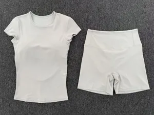 Grey yoga set detail featuring a short-sleeve athletic top and high-waist shorts for fitness.